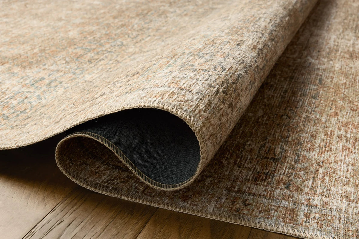 Close-up of the Cambria rug highlighting the woven jute texture and subtle Ocean blue and Brick color palette.