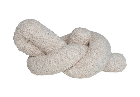 Cream bouclé knot pillow featuring a textured woven cotton surface and sculptural design.