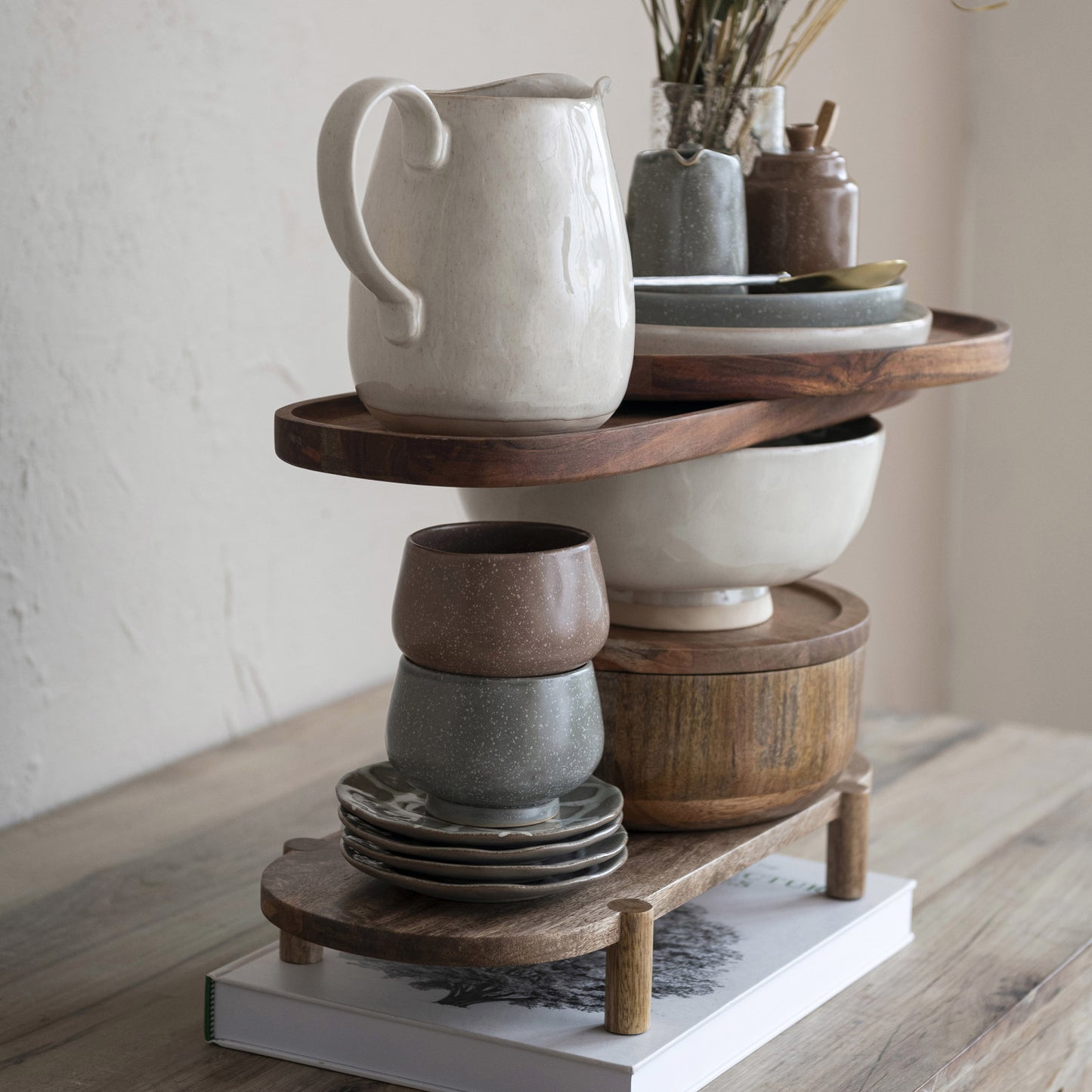 Cream stoneware footed bowl displayed in an organic modern home with layered décor and warm neutral tones.