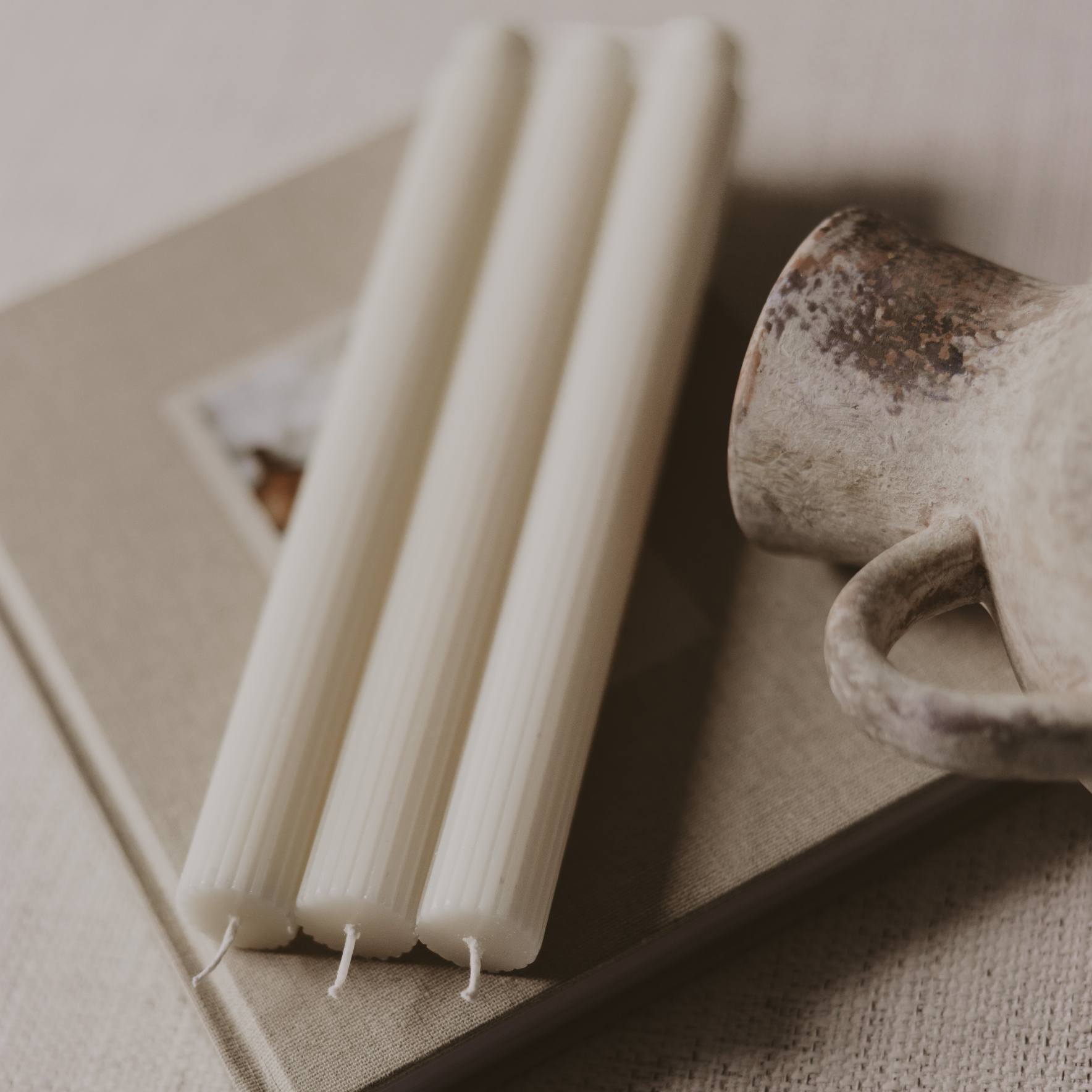 Close-up of the fluted texture and clean white finish of the unscented taper candles.