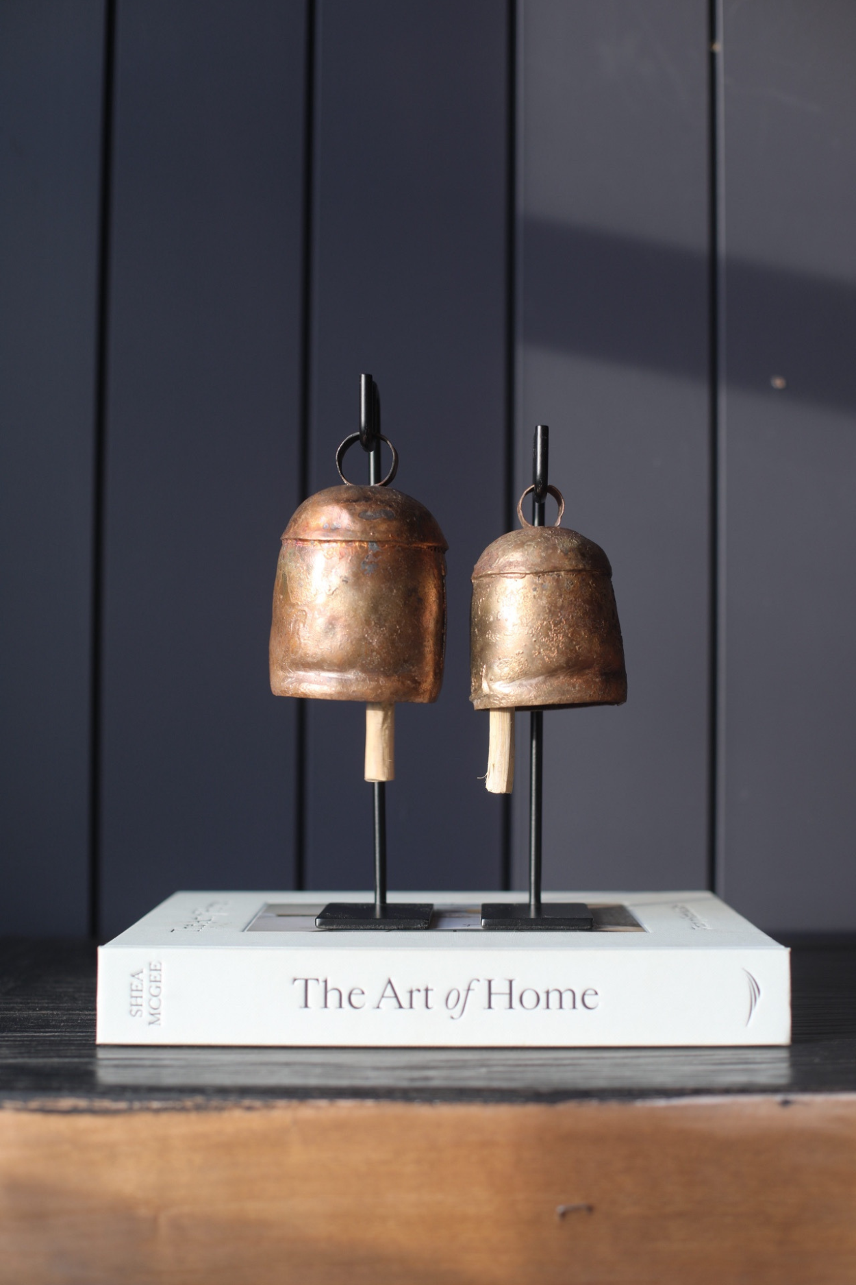 Vintage inspired iron bell stands with weathered patina and handcrafted detailing, set of 2 styled on shelf decor