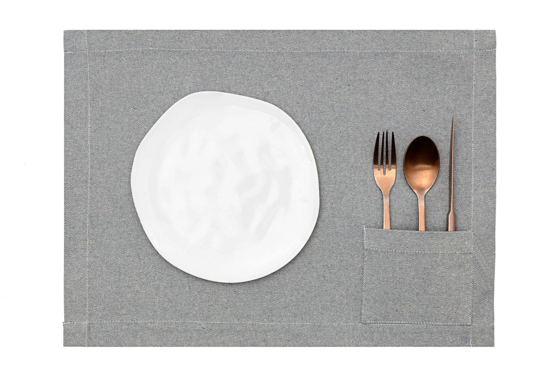 Set of four denim placemats featuring integrated pockets for flatware and napkins.