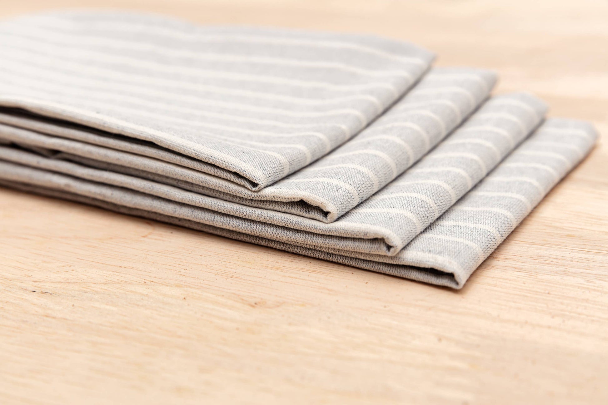 Cotton cloth napkin featuring a classic blue stripe pattern and soft texture.