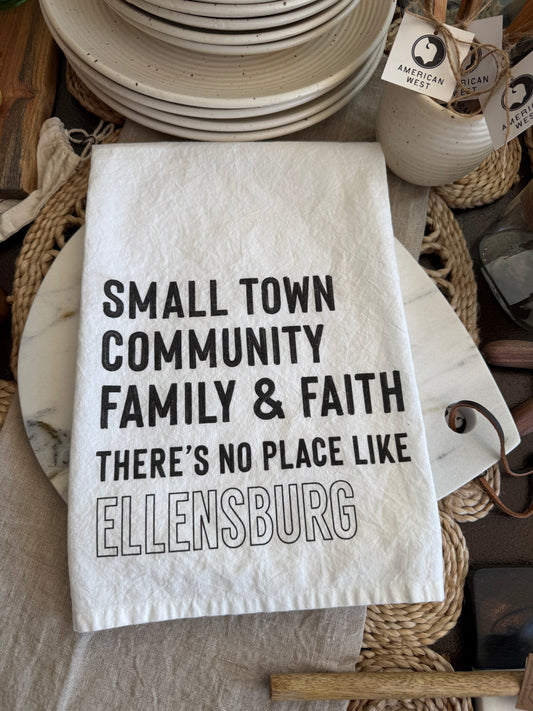 Ellensburg Small Town cotton tea towel styled in a warm neutral kitchen with corner hanging loop