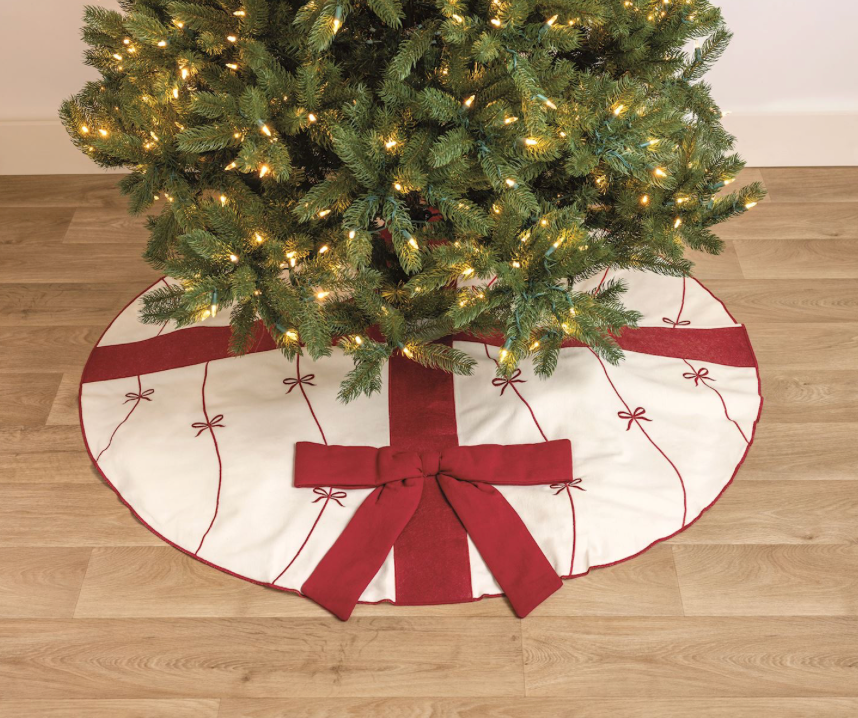 Embroidered cotton canvas Christmas tree skirt with dimensional bow details and felted wool ribbon.