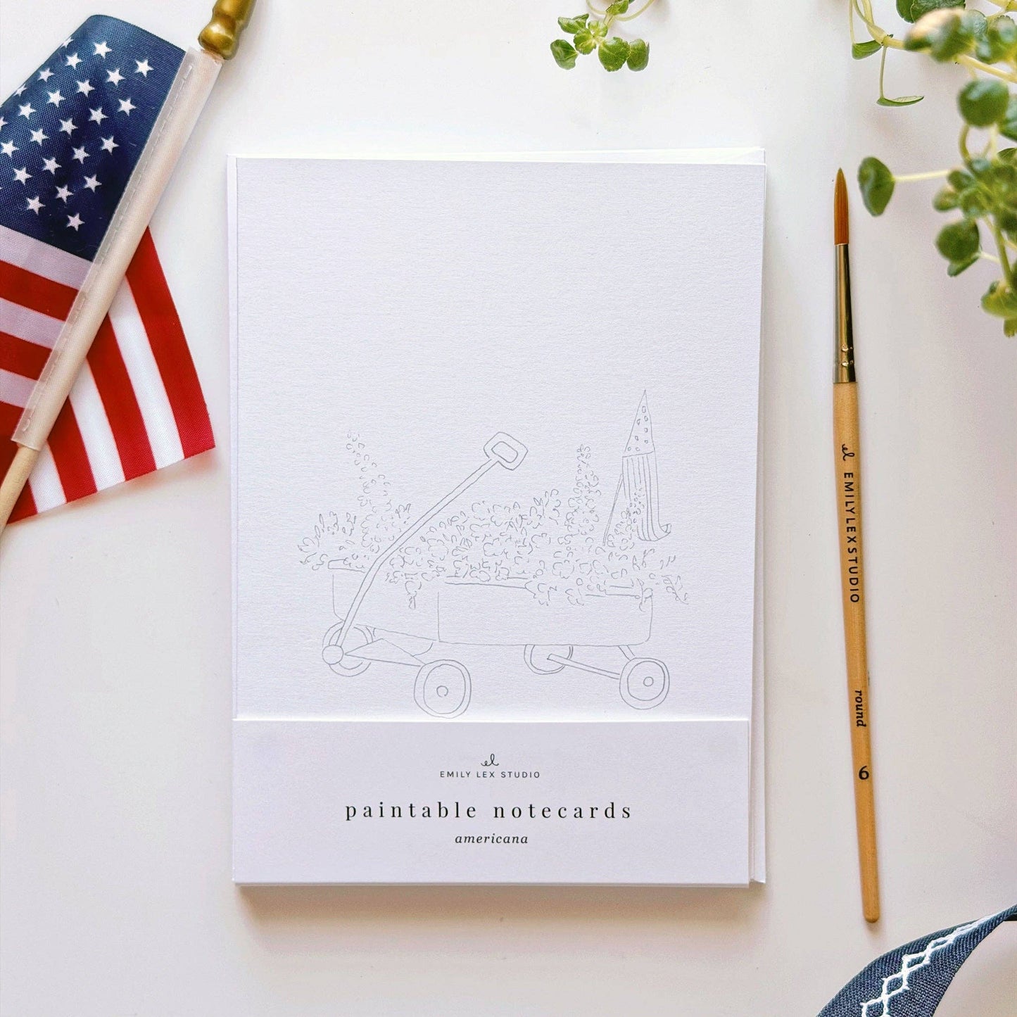 Americana paintable notecard set styled with watercolor supplies and summer stationery.
