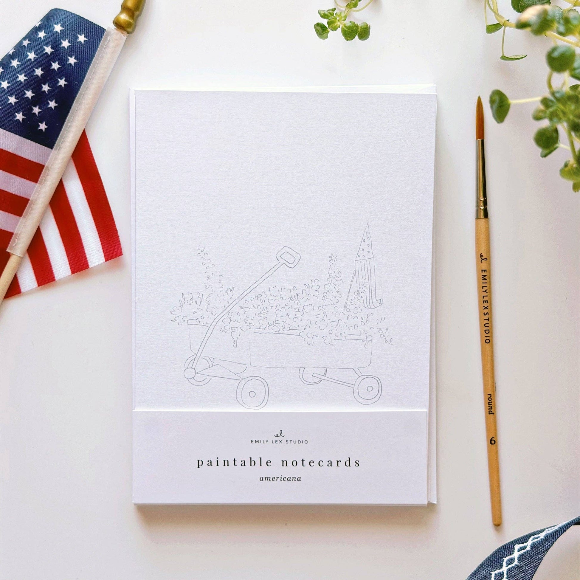 Americana paintable notecard set styled with watercolor supplies and summer stationery.