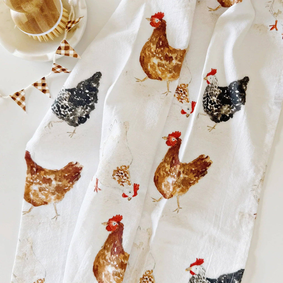 Close-up of original farm chicken watercolor illustrations on the Emily Lex cotton kitchen towel.