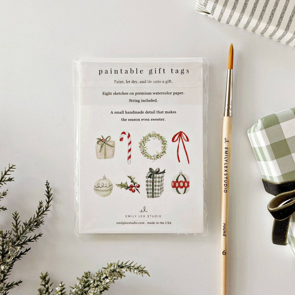 Set of eight Christmas gift tags by Emily Lex featuring different lightly sketched holiday illustrations.