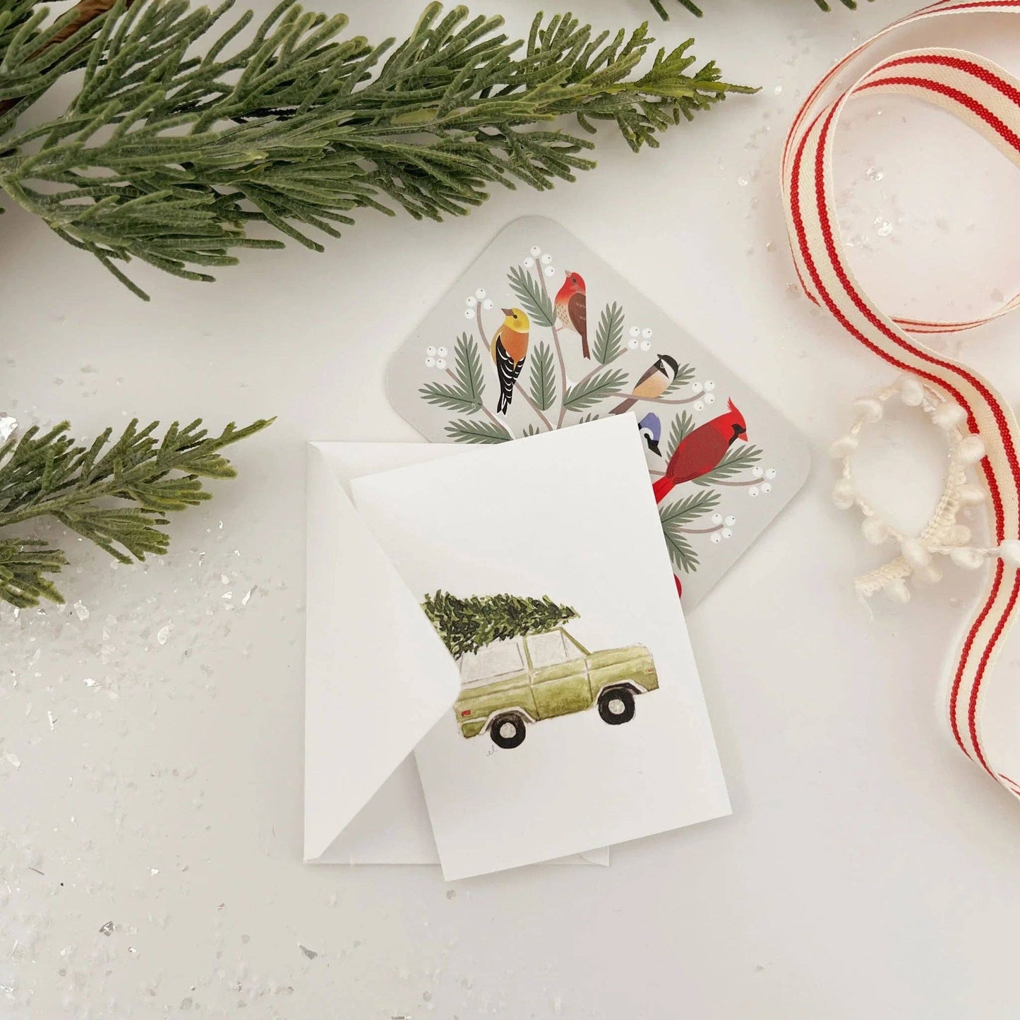 Christmas Tree Truck Mini Enclosure Card by Emily Lex featuring an original watercolor illustration of a vintage truck carrying a Christmas tree.