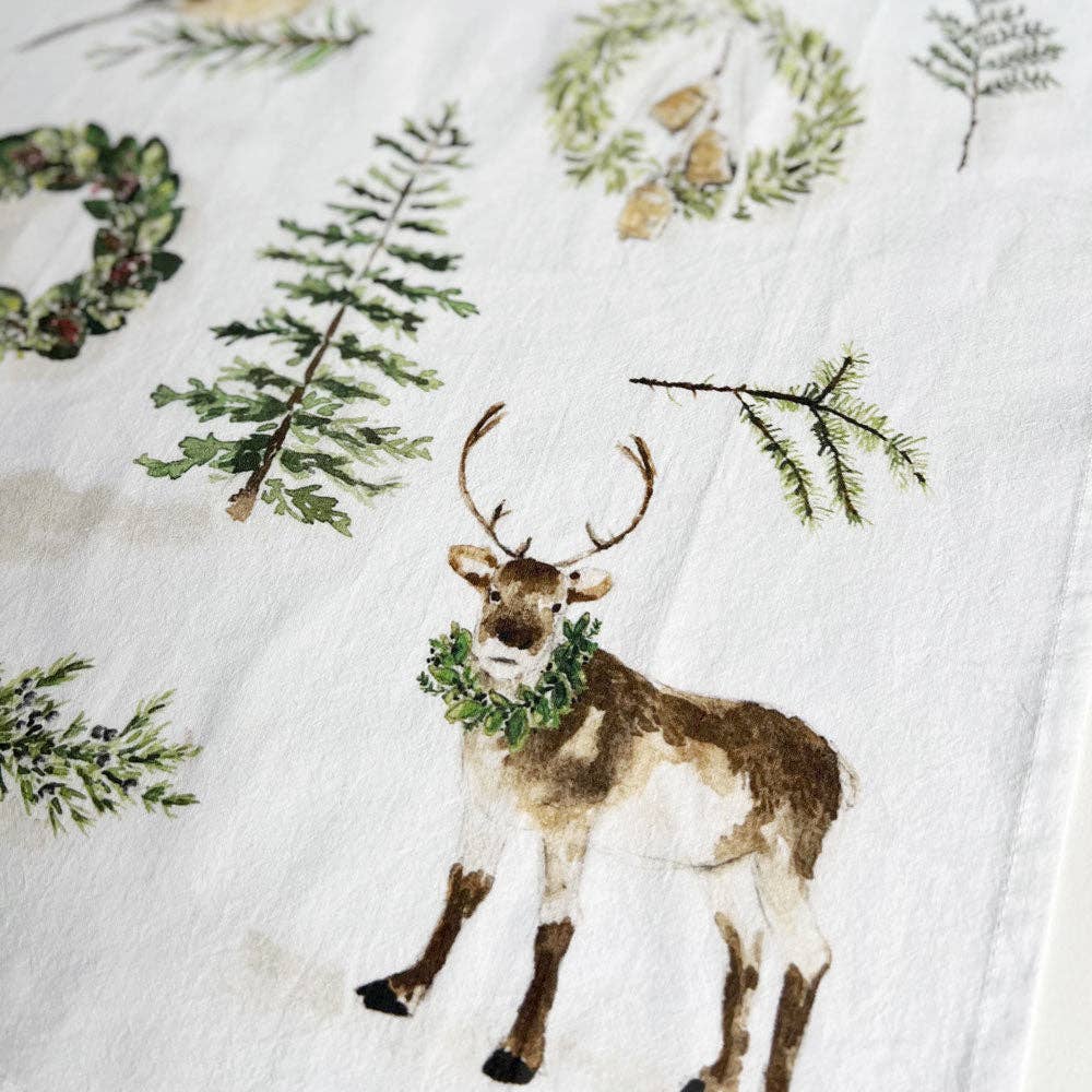 Close-up of the evergreen watercolor pattern printed on a 100% cotton flour sack tea towel with a convenient hanging loop.