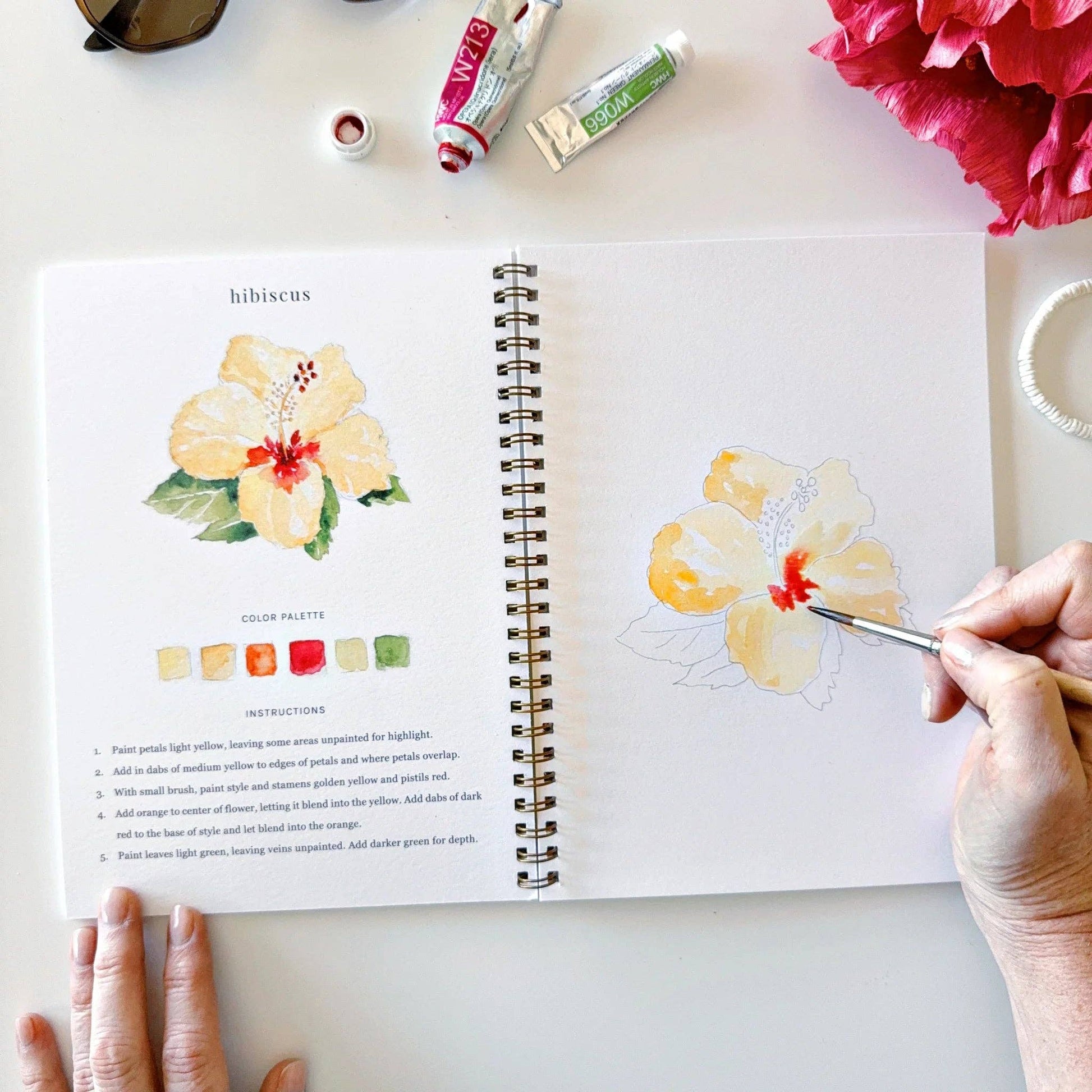 Tropical watercolor workbook with outlined illustrations and step-by-step painting instruction.