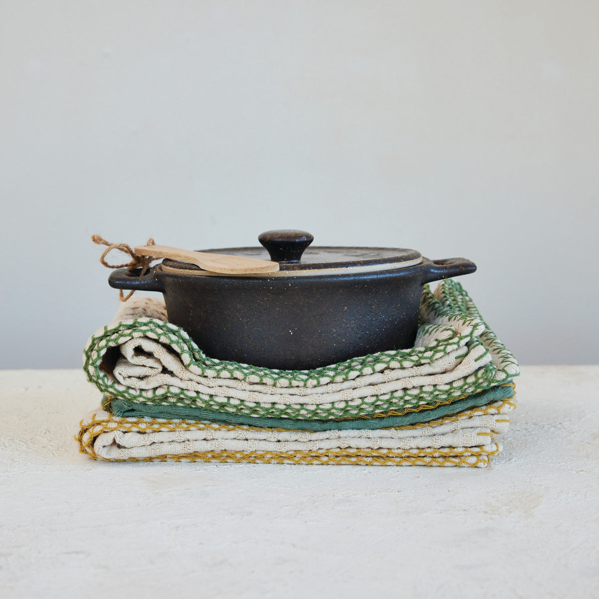 Espresso brown stoneware brie baker with a matte reactive glaze and bamboo serving spreader.