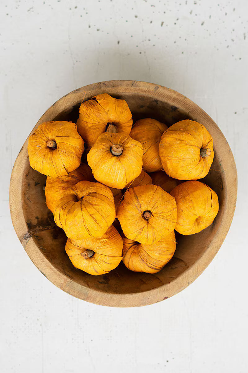 Bag of 15 miniature faux pumpkins in warm orange tones for seasonal decorating.