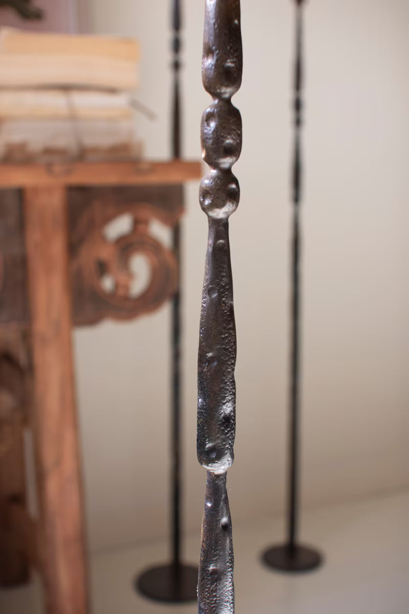 Close-up of the handcrafted forged iron construction and warm antique brass finish.