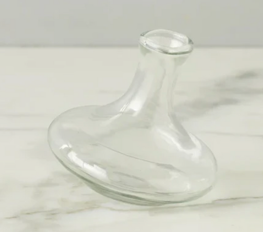Clear glass vase on a white marble surface