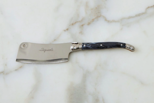 Butterfly knife with blue handle on a marble surface
