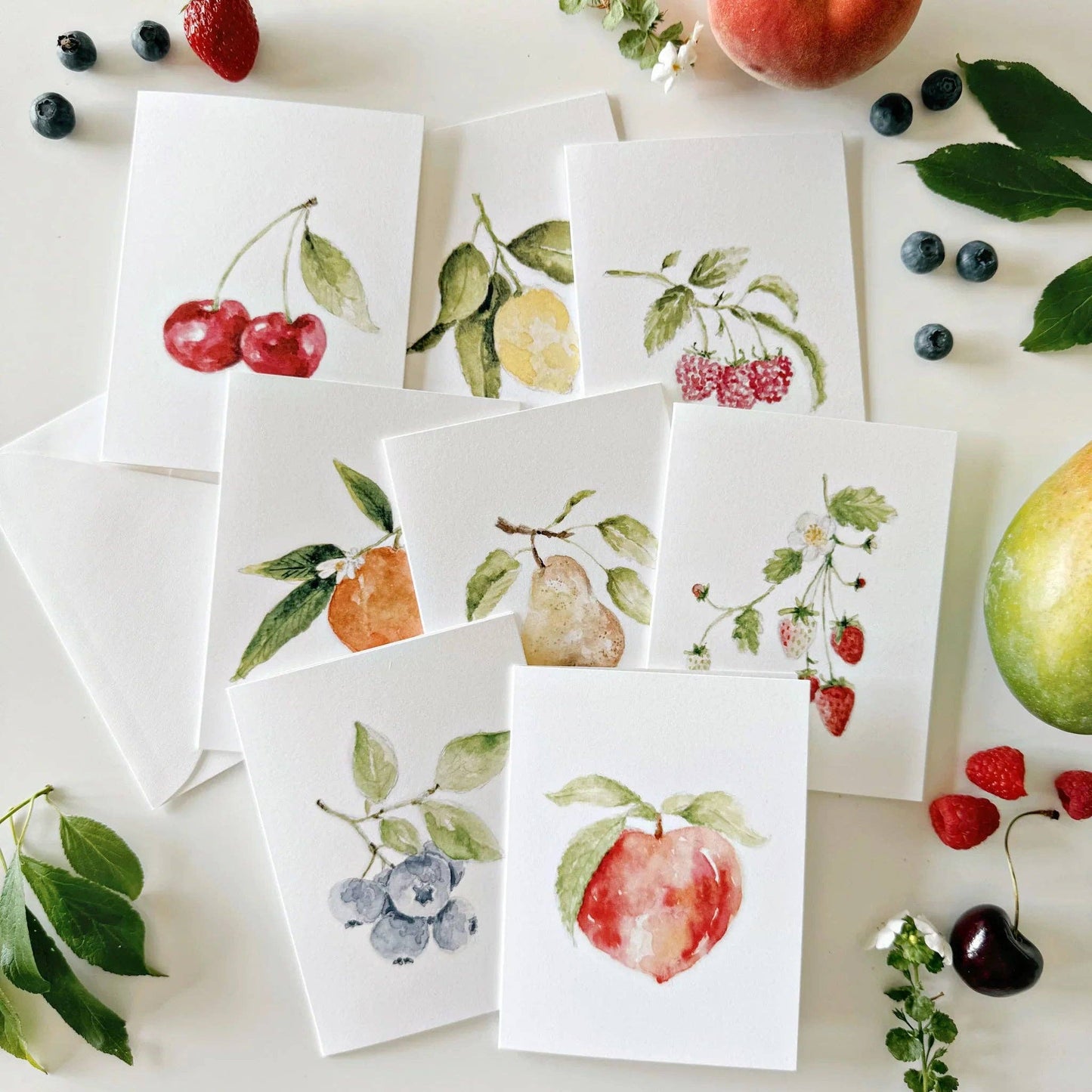 Assorted fruit watercolor greeting cards printed on premium 120 lb superfine paper with blank interiors for personalized messages.