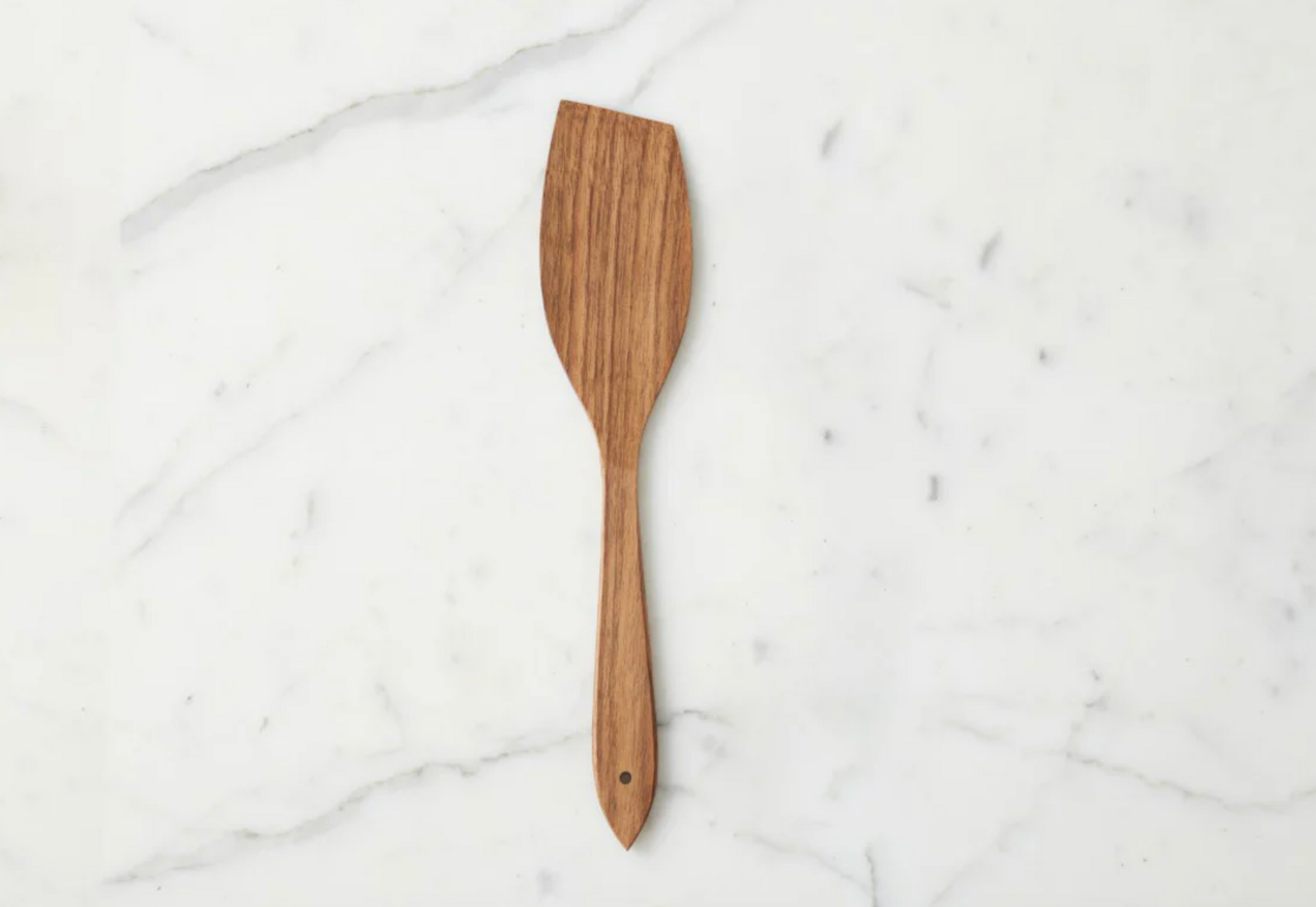 Handcrafted fruitwood flat spatula made from sustainable European wood styled in a warm neutral kitchen