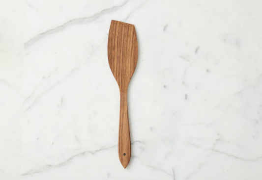 Handcrafted fruitwood flat spatula made from sustainable European wood styled in a warm neutral kitchen