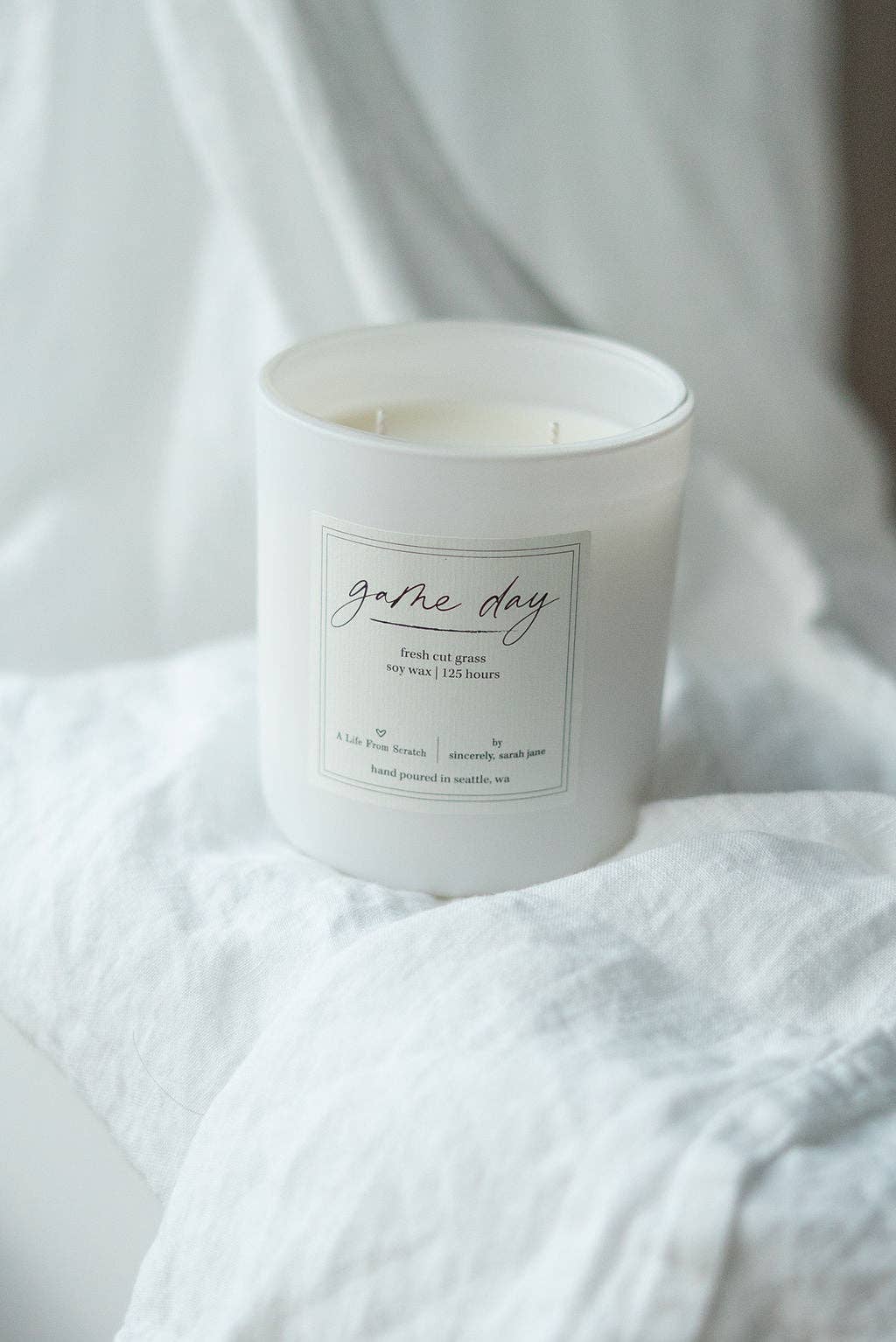 Game Day soy candle with a fresh cut grass, citrus, and sage fragrance.