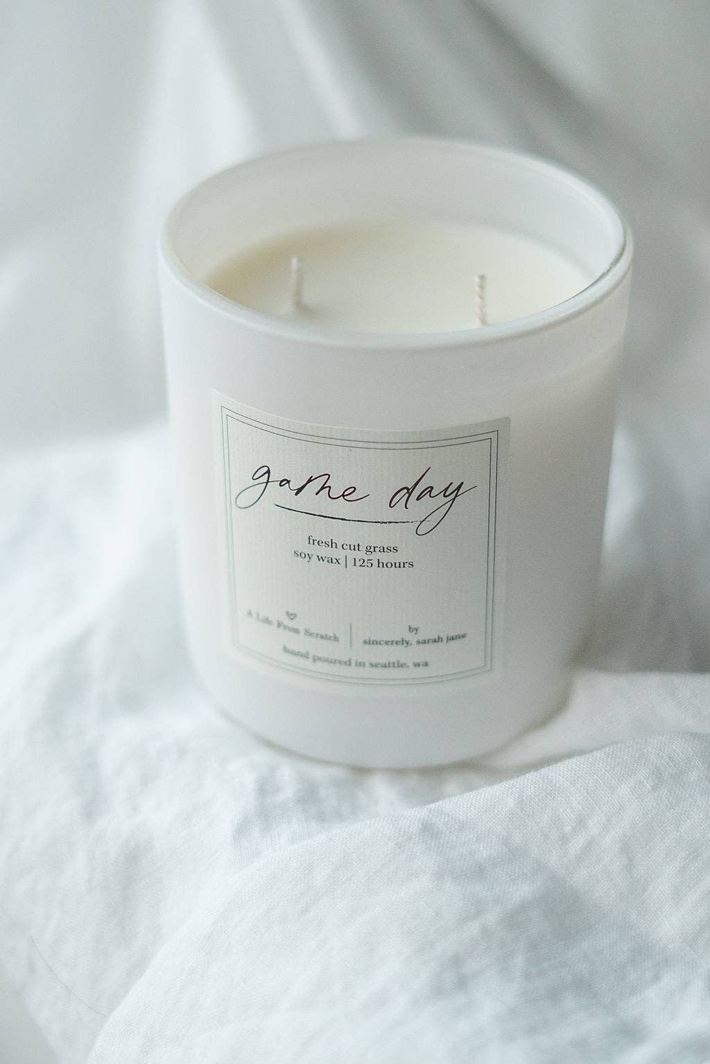 Game Day soy candle with a fresh cut grass, citrus, and sage fragrance.