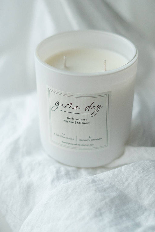 Game Day soy candle with a fresh cut grass, citrus, and sage fragrance.