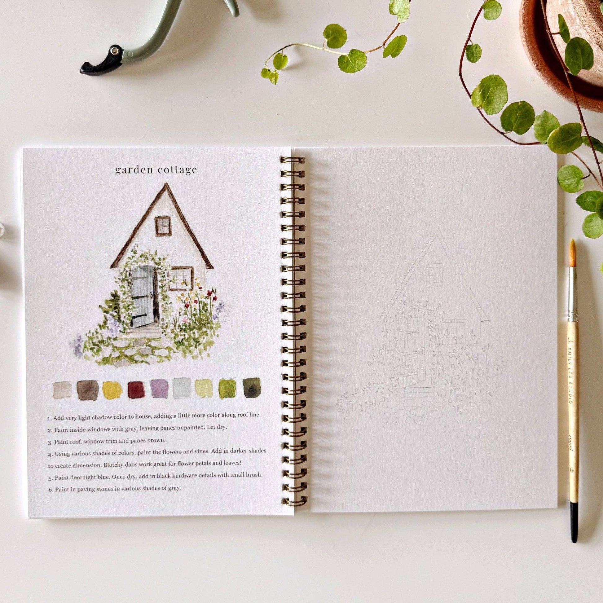 Spiral-bound watercolor workbook with lightly sketched garden illustrations ready to paint.
