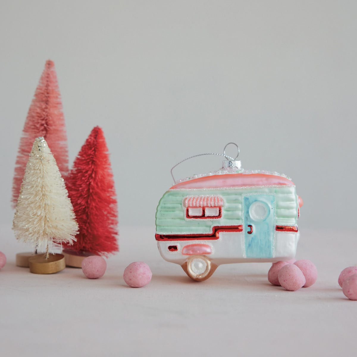 Hand-painted glass camper Christmas ornament with colorful details, sparkling glitter, and decorative beads.