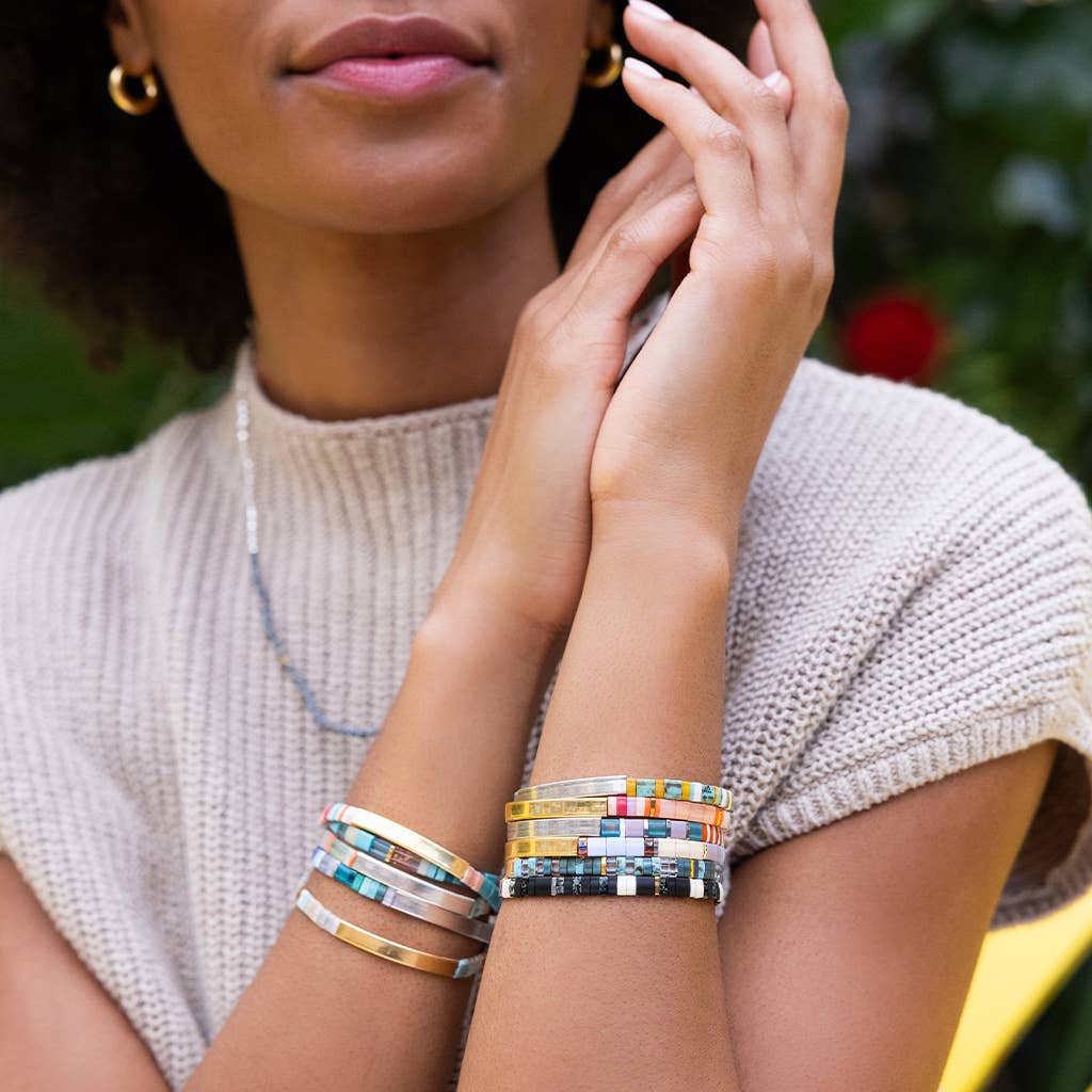 Good Karma Miyuki Bracelet featuring mint, peach, and gold Japanese Miyuki glass beads with a 14K gold-dipped engraved bar and Sparkle & Shine leather keepsake tag.
