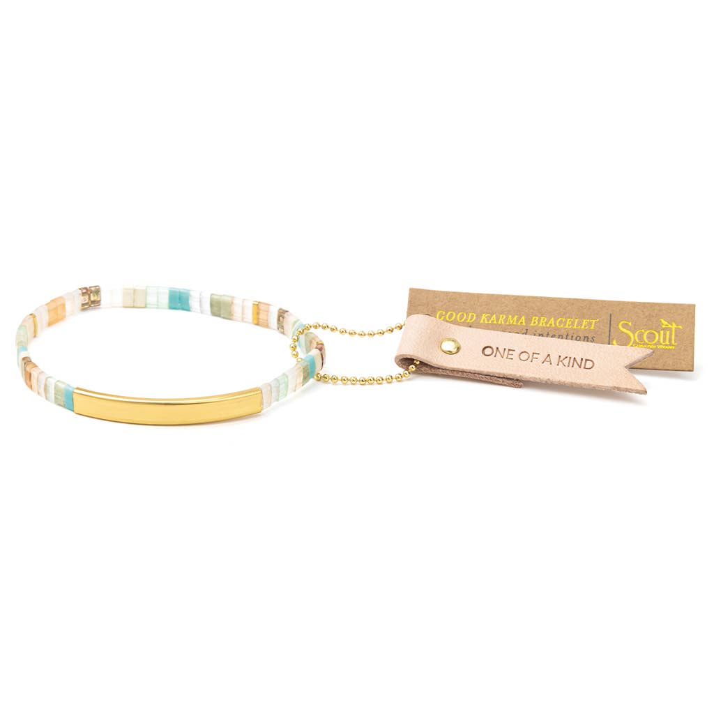 Good Karma Miyuki Bracelet featuring mint, peach, and gold Japanese Miyuki glass beads with a 14K gold-dipped engraved bar and Sparkle & Shine leather keepsake tag.
