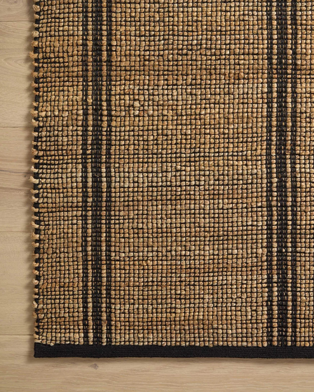 Close-up of the Colton rug showcasing the woven jute and cotton texture, natural fibers, and artisan craftsmanship.