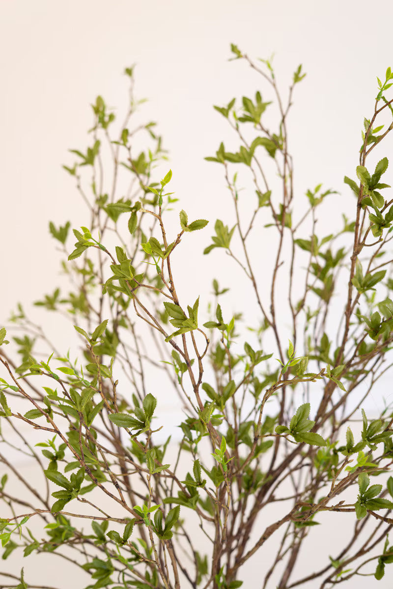 Close-up of the faux green berries and budding leaves showcasing lifelike botanical details.