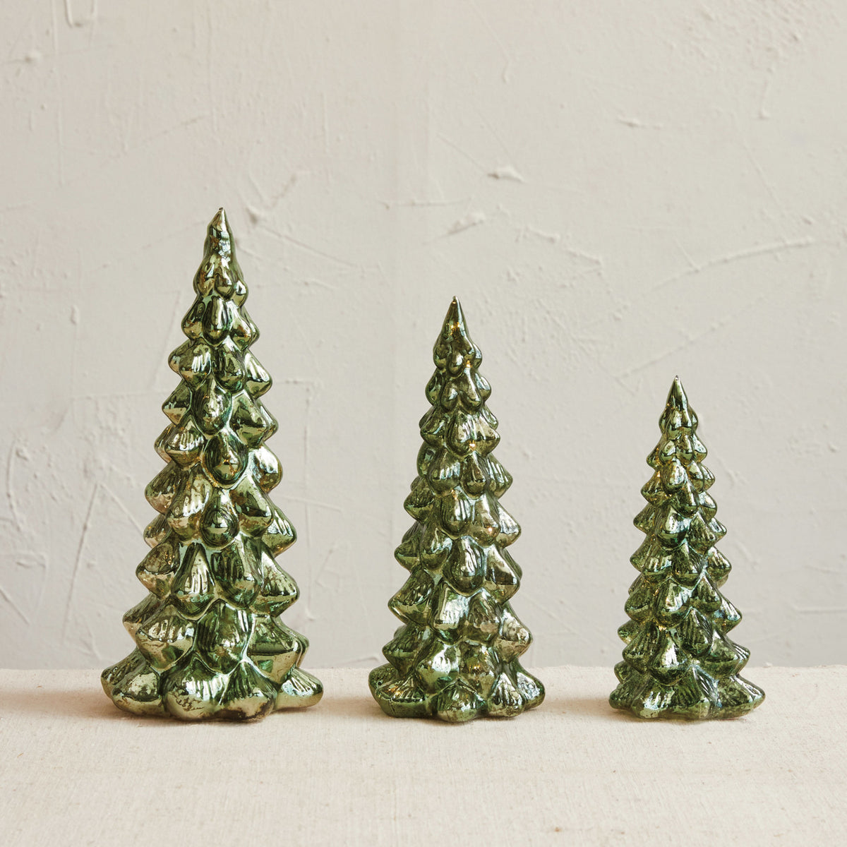Set of three green mercury glass LED Christmas trees in graduated sizes with a softly illuminated vintage-inspired finish.
