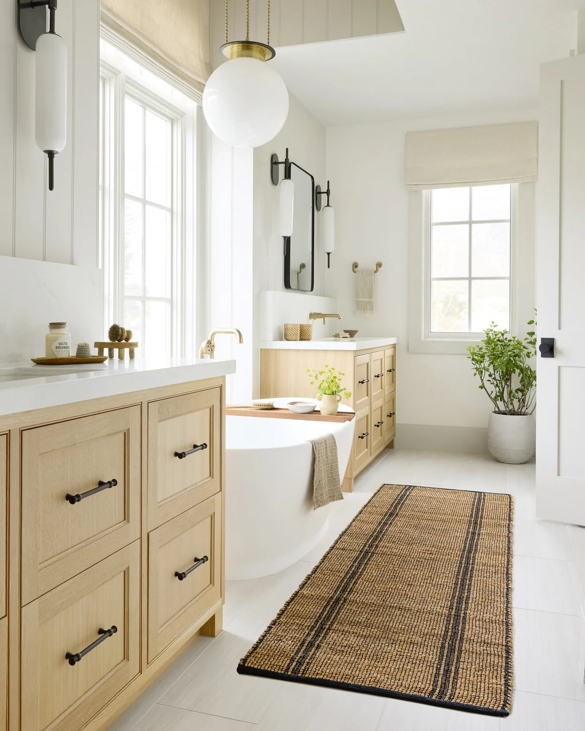 Colton handwoven area rug in Natural and Black featuring a timeless linear pattern crafted from a soft jute and cotton blend.