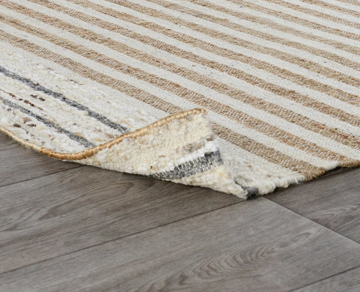 Close-up of the Pego Stripe rug highlighting the rich woven texture and natural blend of jute, wool, and cotton fibers.