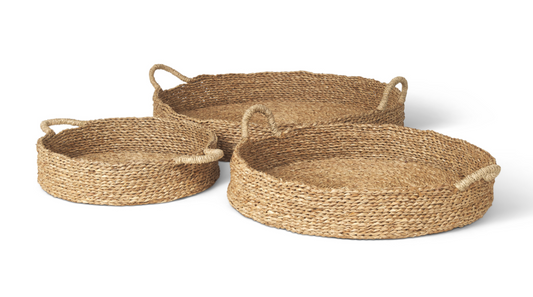 Three sizes of the handwoven Ulana seagrass storage tray with integrated loop handles.