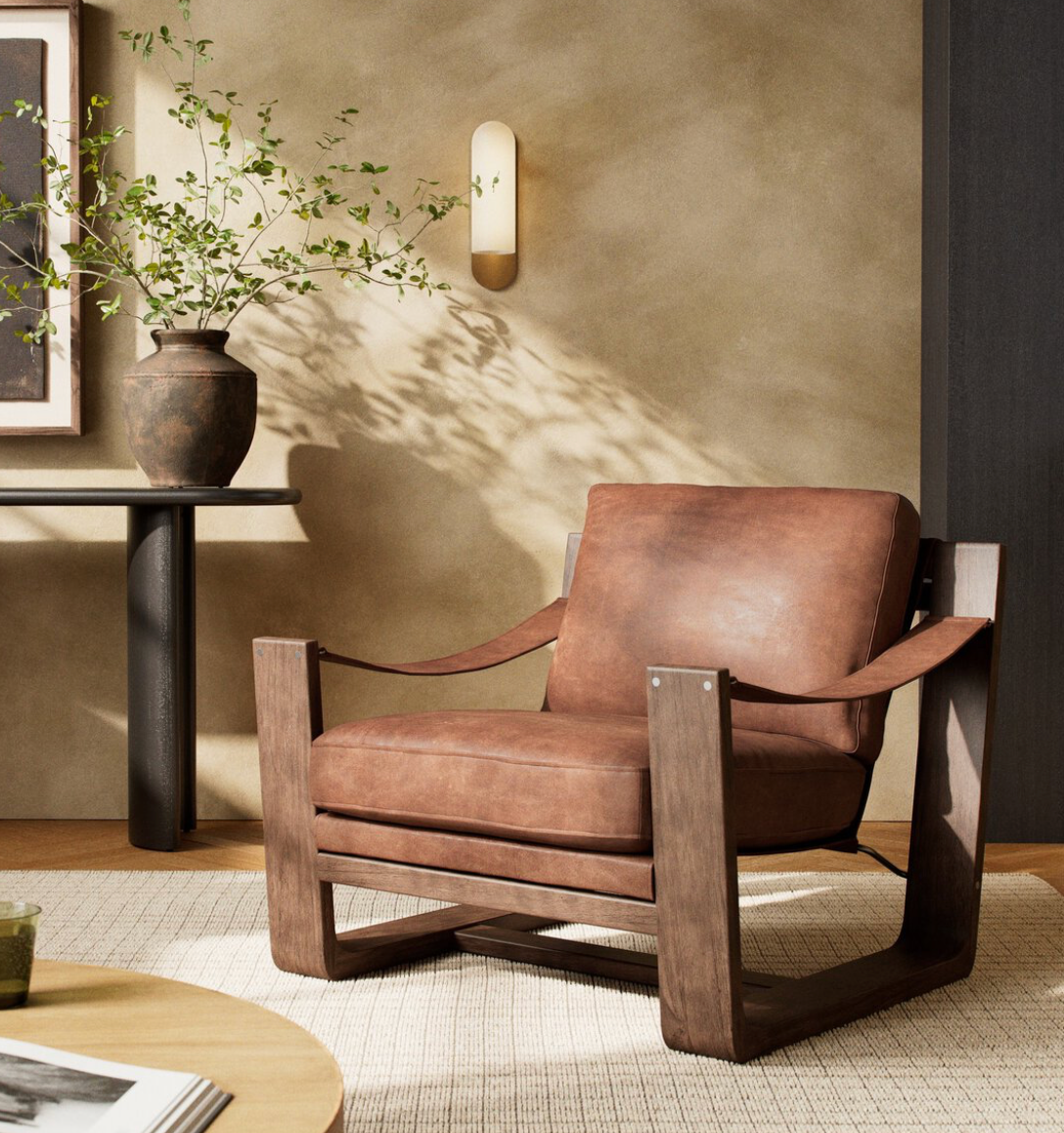 Sierra Heirloom Sienna Leather Sling Chair styled as a warm accent chair in a living space.