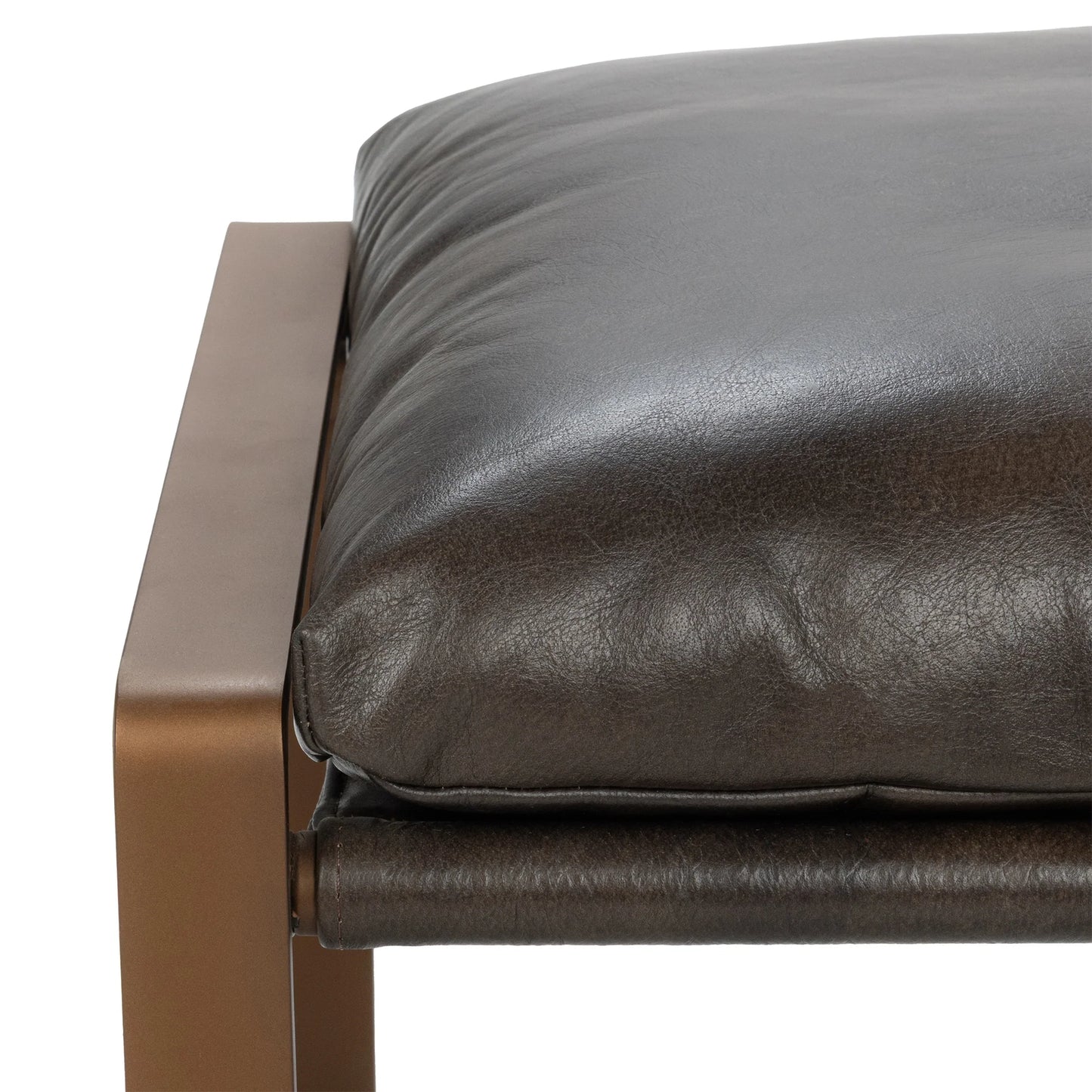 Close-up of the Morgan ottoman showcasing the rich texture of the top grain leather cushion and minimalist iron frame.