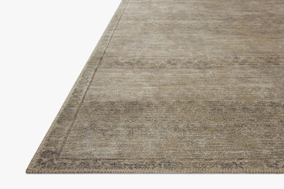 Close-up of the Cambria rug highlighting the weathered vintage motif, woven jute texture, and low-profile construction.