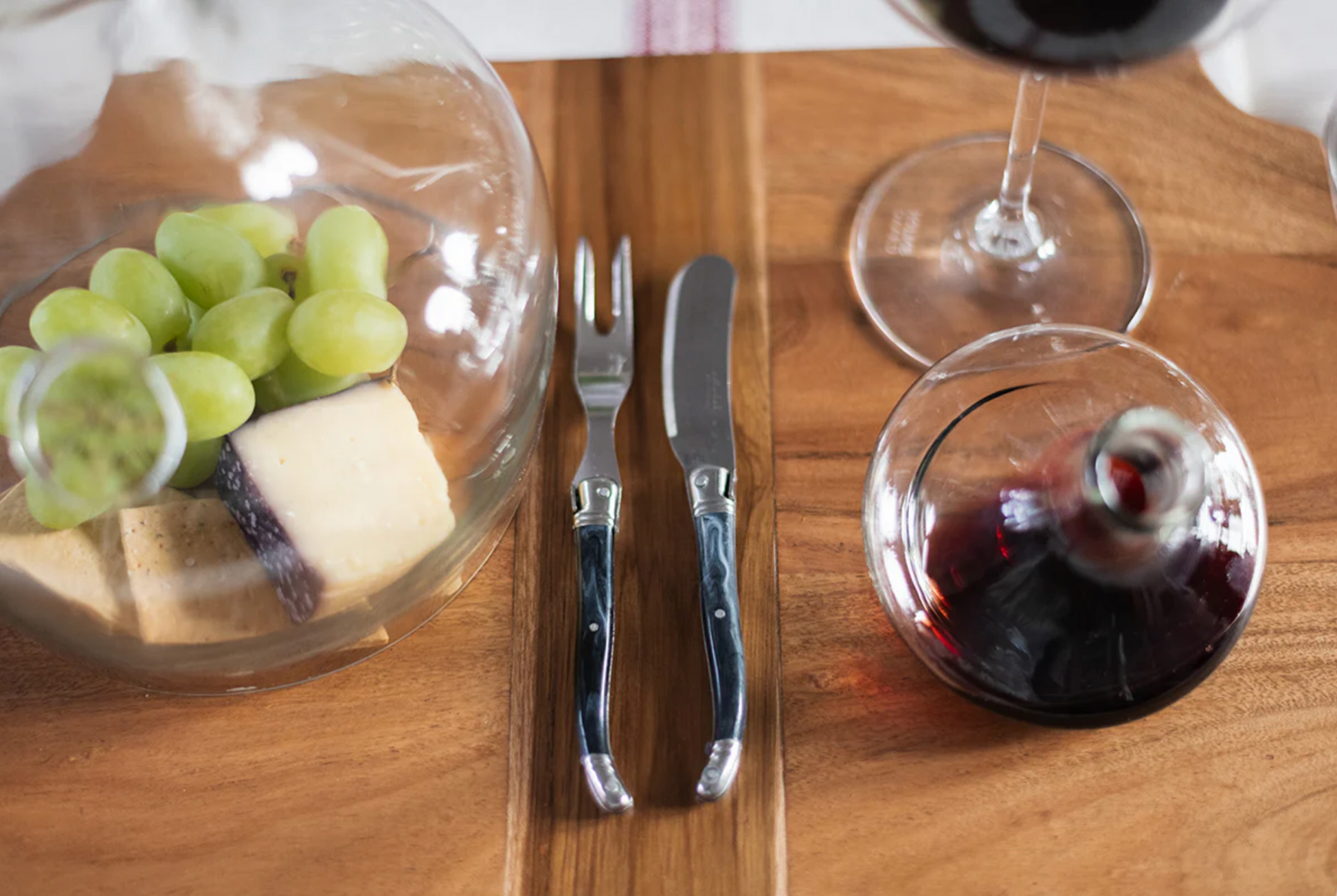 French Laguiole cheese fork with marbled grey handle styled on an artisan charcuterie board for gathered entertaining