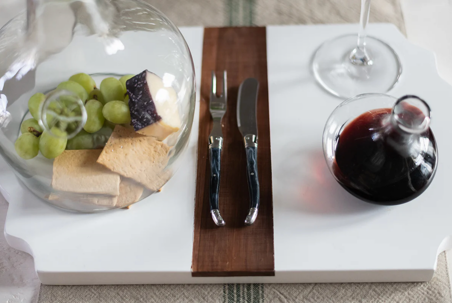 French Laguiole spreader with marbled grey handle styled on an artisan charcuterie board for gathered entertaining