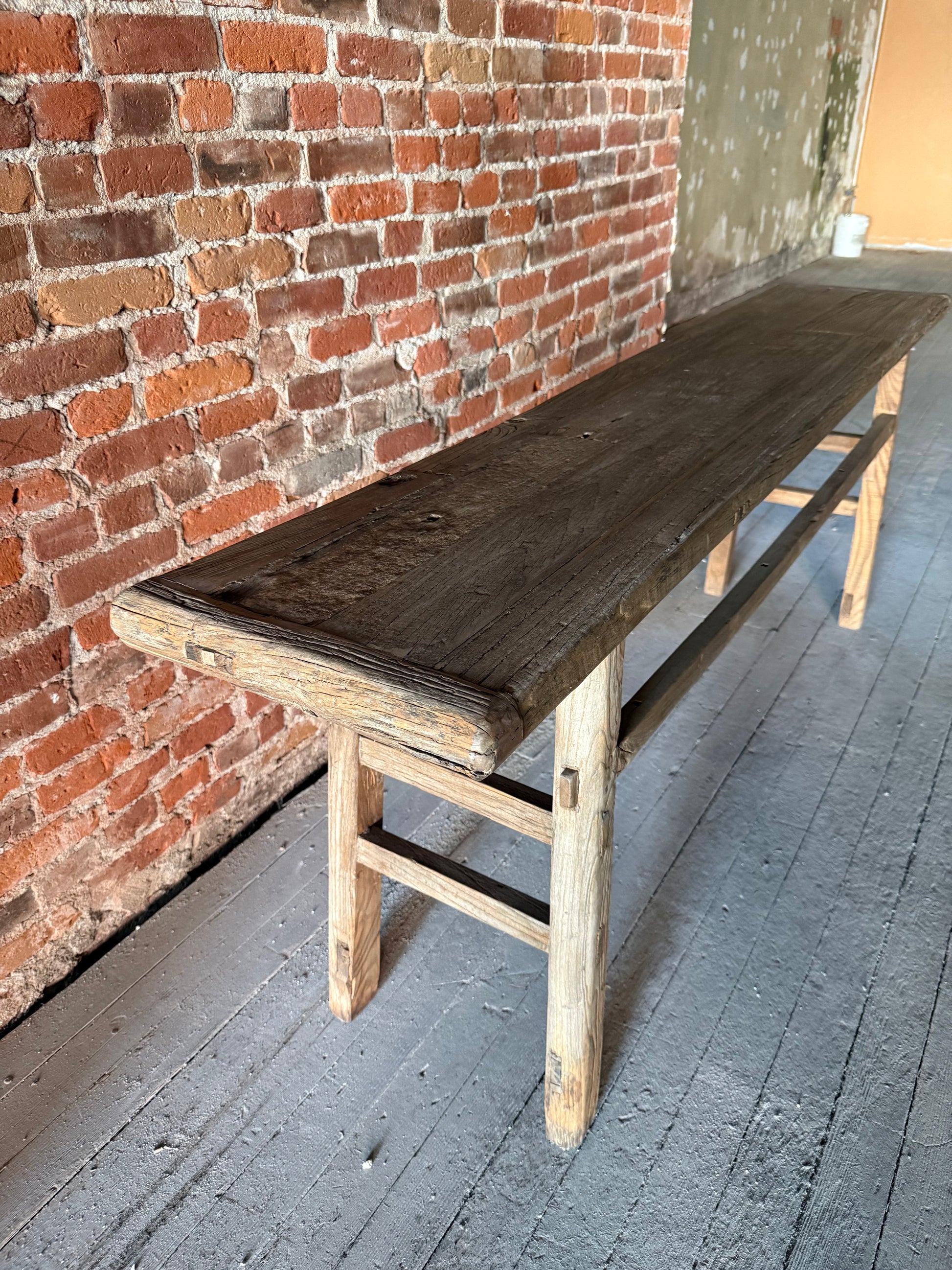 Reclaimed solid wood console table with natural grain variation and handcrafted texture.