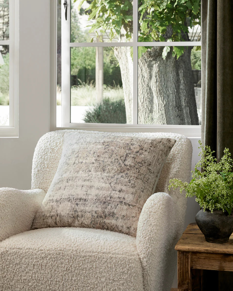 Larkspur throw pillow layered on a neutral sofa in an organic modern living room.