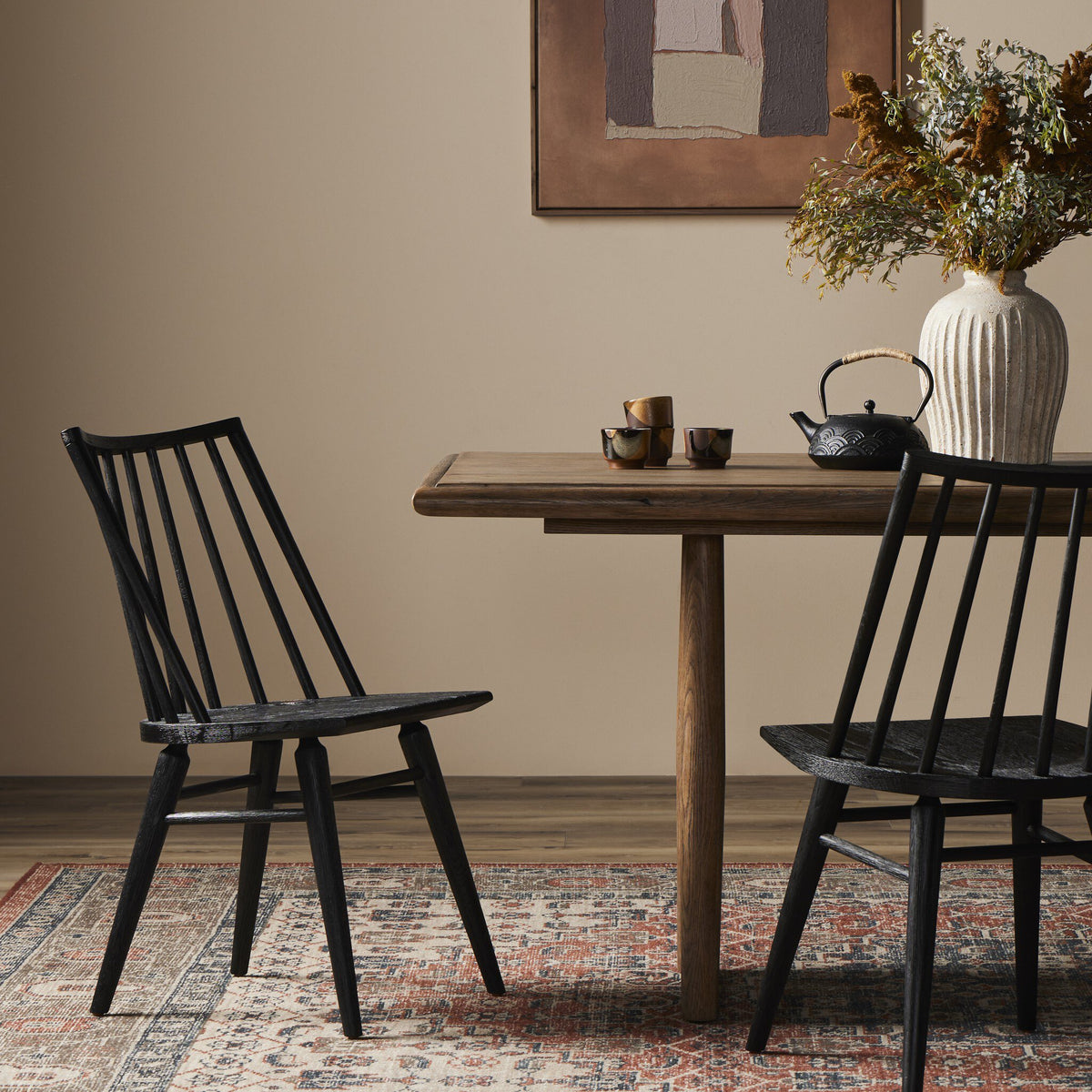 Black oak Windsor dining chairs styled around a warm natural wood dining table.
