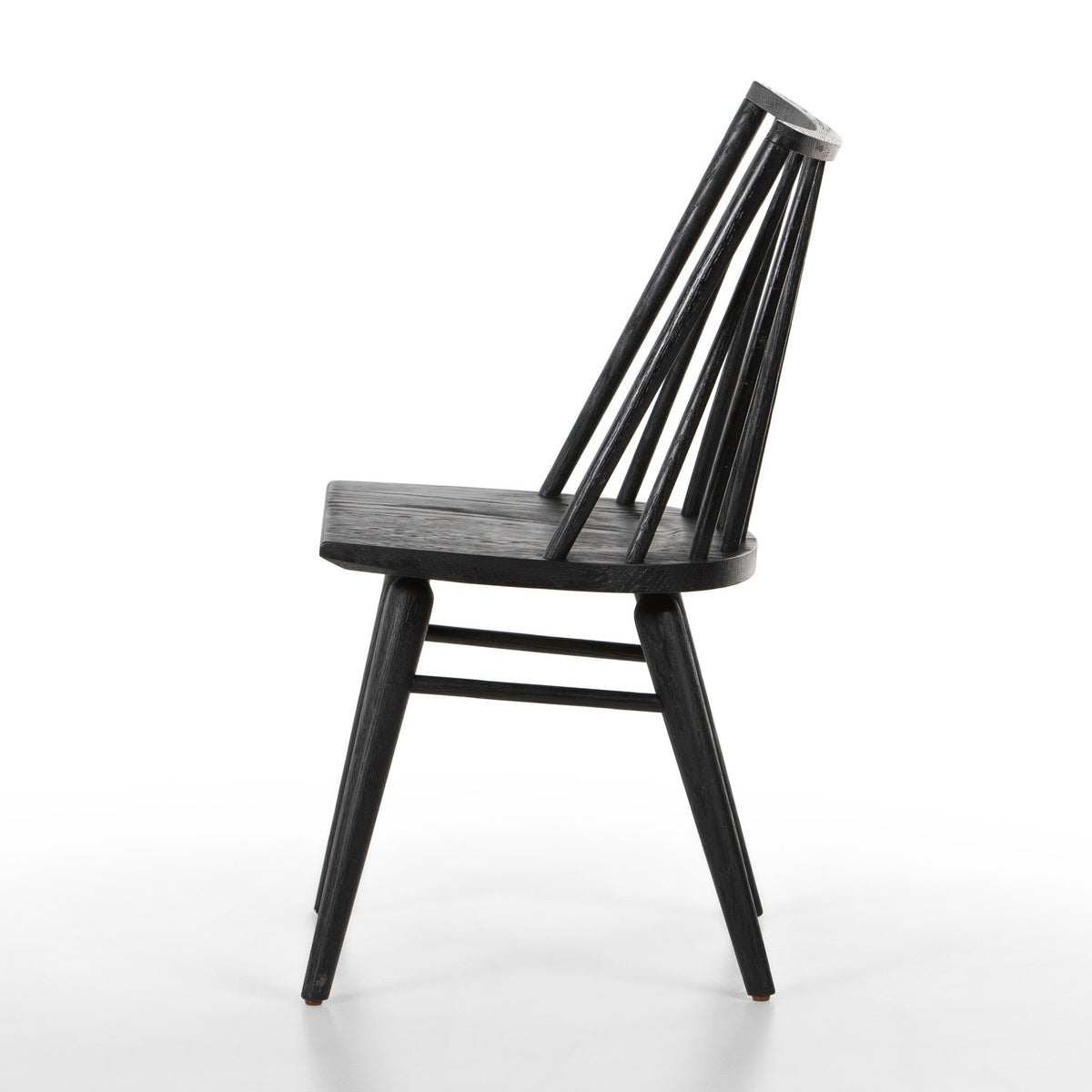 Side view of the Lewis Black Oak Windsor Dining Chair showing its tall spindle back and splayed solid oak legs.