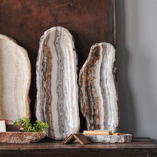 Black Lapiz Long Onyx Tray hand-carved from natural stone with variegated banding, a polished inset, and organic textured edges.