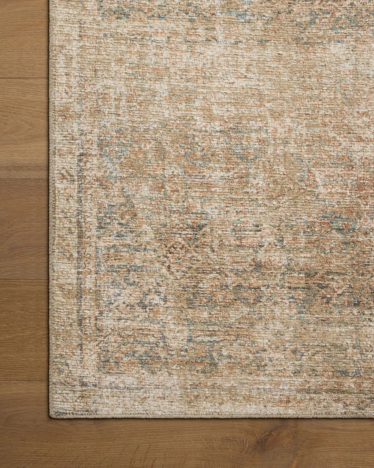 Close-up of the Cambria rug highlighting the woven jute texture and subtle Ocean blue and Brick color palette.