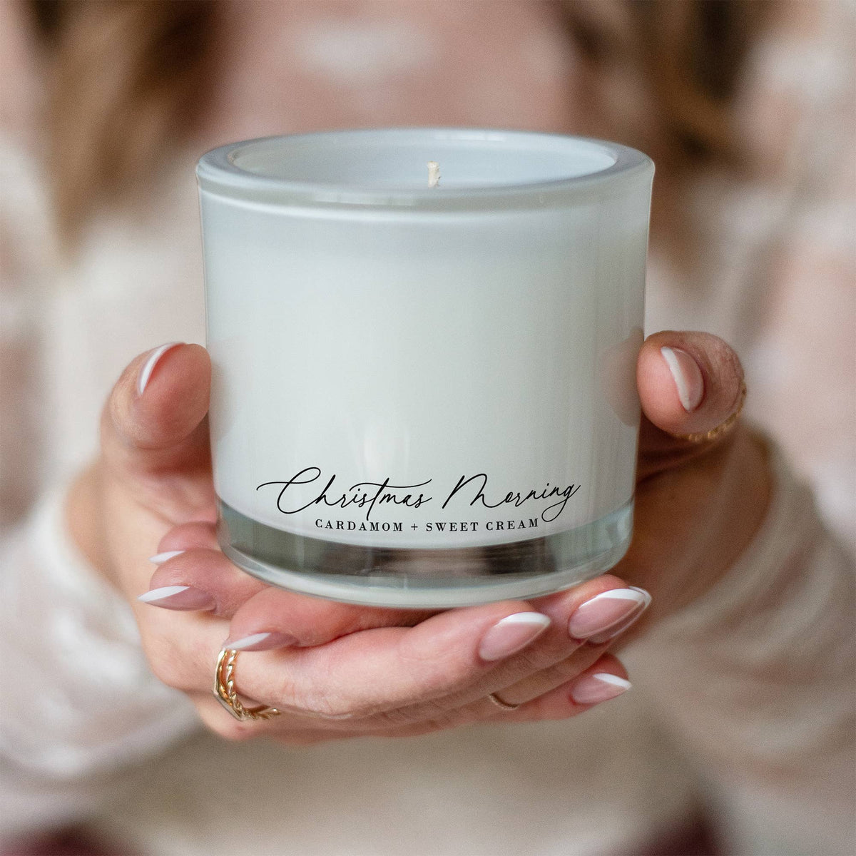 Close-up of the Christmas Morning candle featuring natural coconut wax, a clean-burning cotton wick, and a frosted recycled glass vessel.