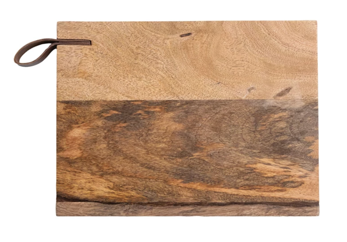 Natural mango wood cheese board with genuine leather handle for serving and display.